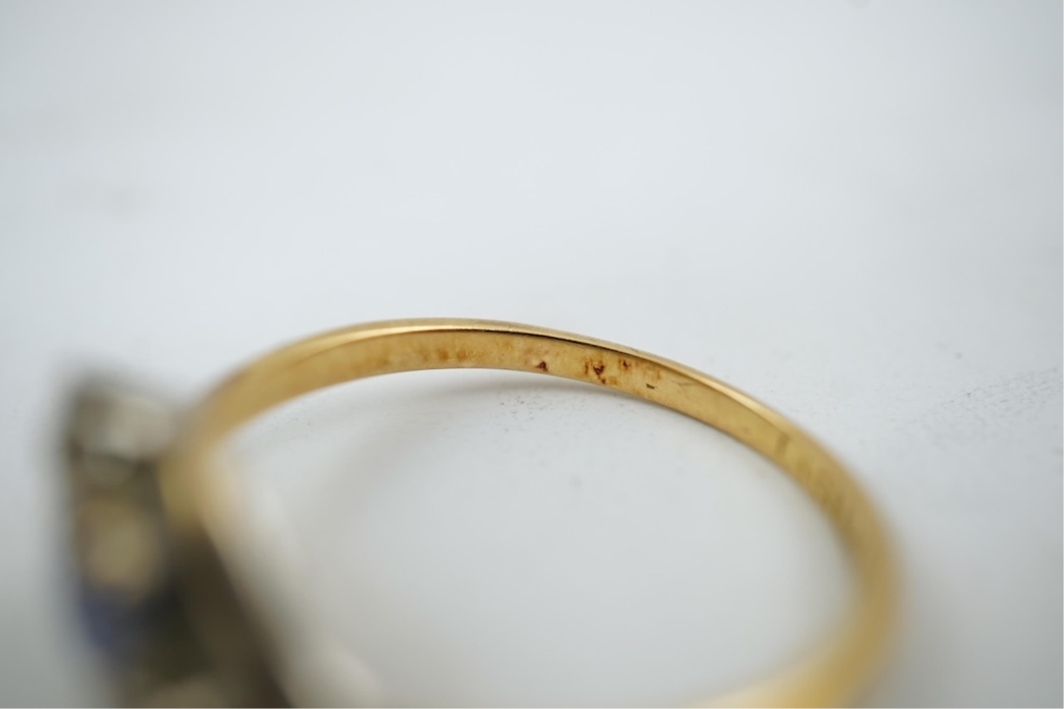 An early 20th century 18ct gold, sapphire and diamond set three stone crossover ring, size P/Q, gross weight 2.4 grams.